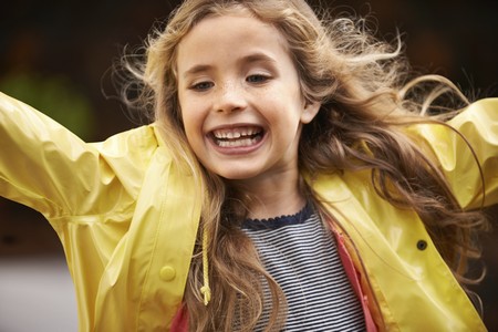 Happy girl in yellow coat